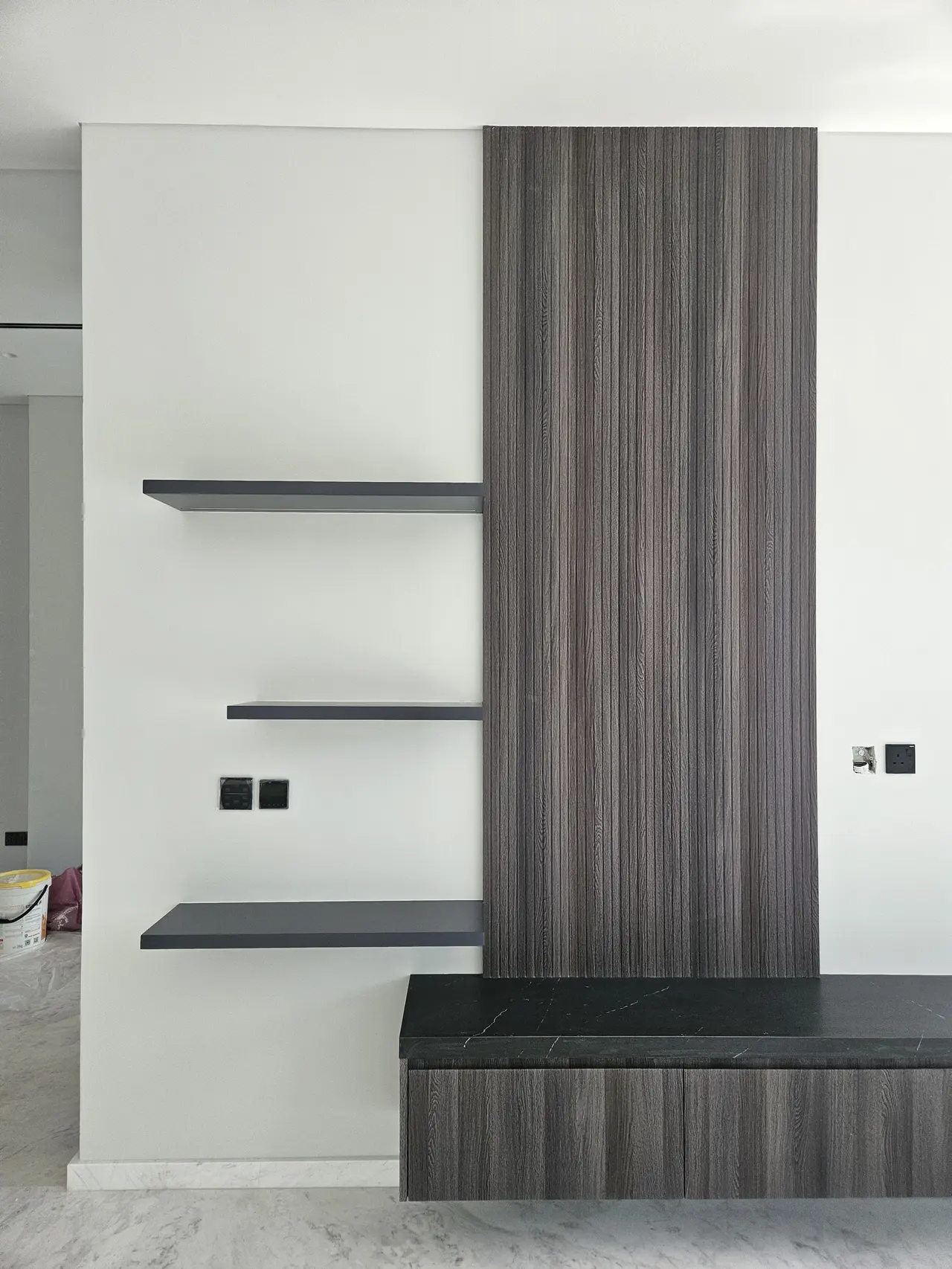 Integrated smart switches beside shelving unit — Emirates Hills villa, obliq